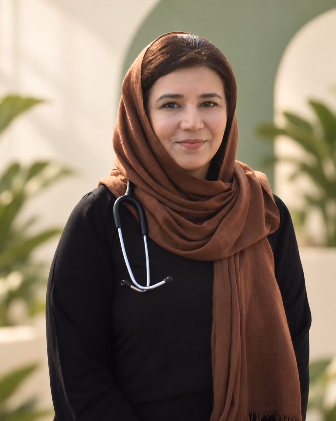 Dr Saba Masoud in a brown headscarf, with a stethoscope around her neck